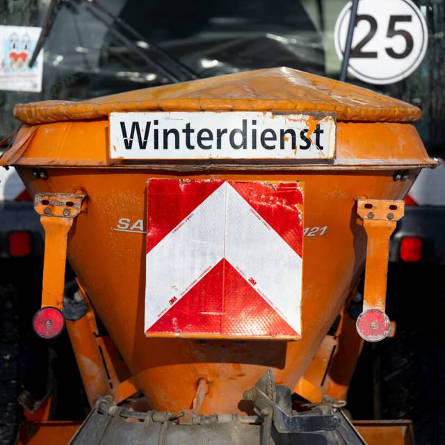 Ein Schneeräumfahrzeug vom Winterdienst der Stadt München steht auf einem Fußweg.
