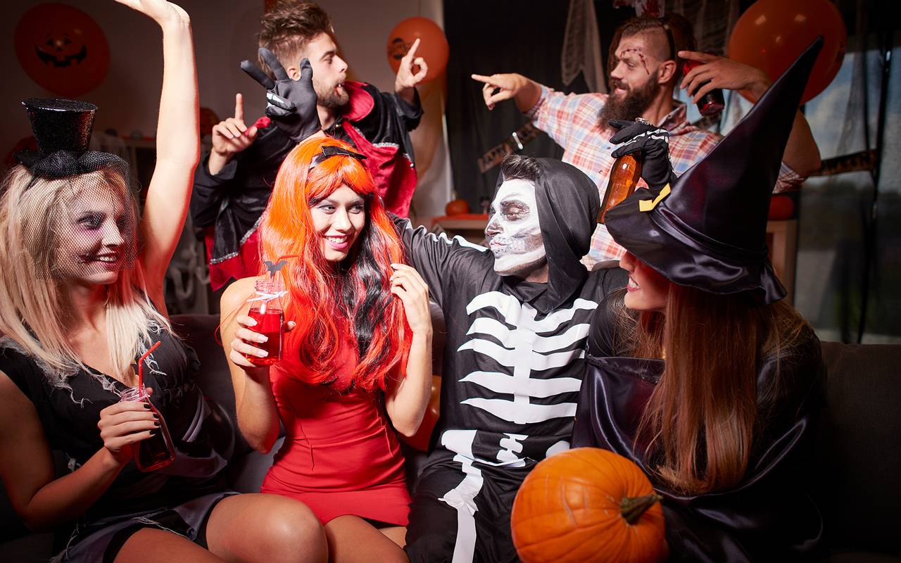 Menschen feiern in Kostümen Halloween.