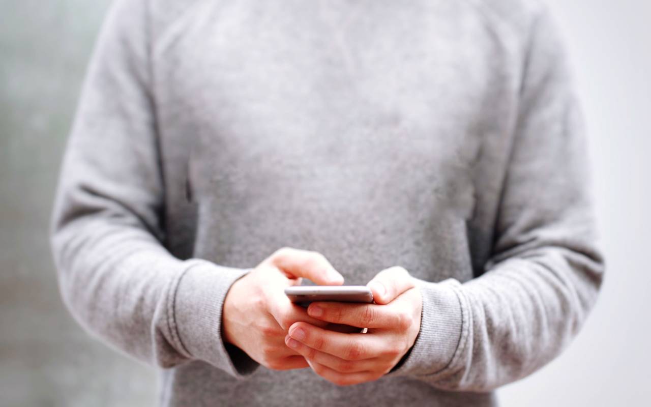 Eine Person hält ein Smartphone in der Hand