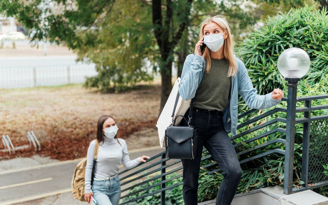 Zwei Frauen im Park tragen eine Maske