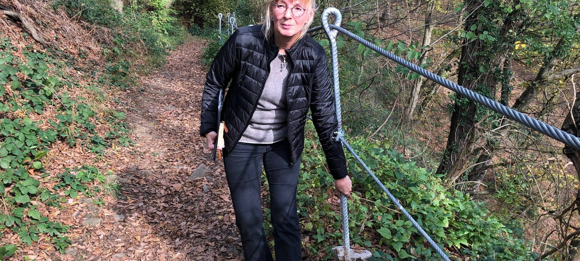 Heike Volz zeigt die beschädigten Seile des Wanderweges in Hohensyburg.