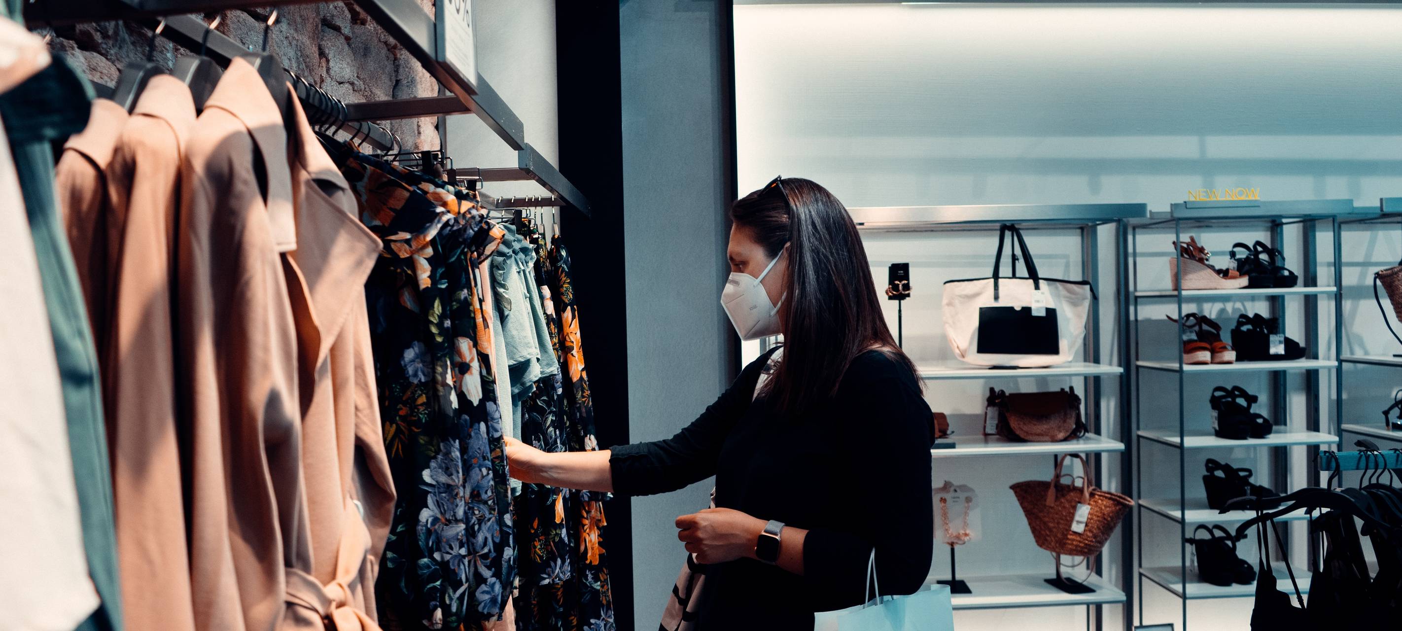 Frau geht einkaufen mit Mundschutz.