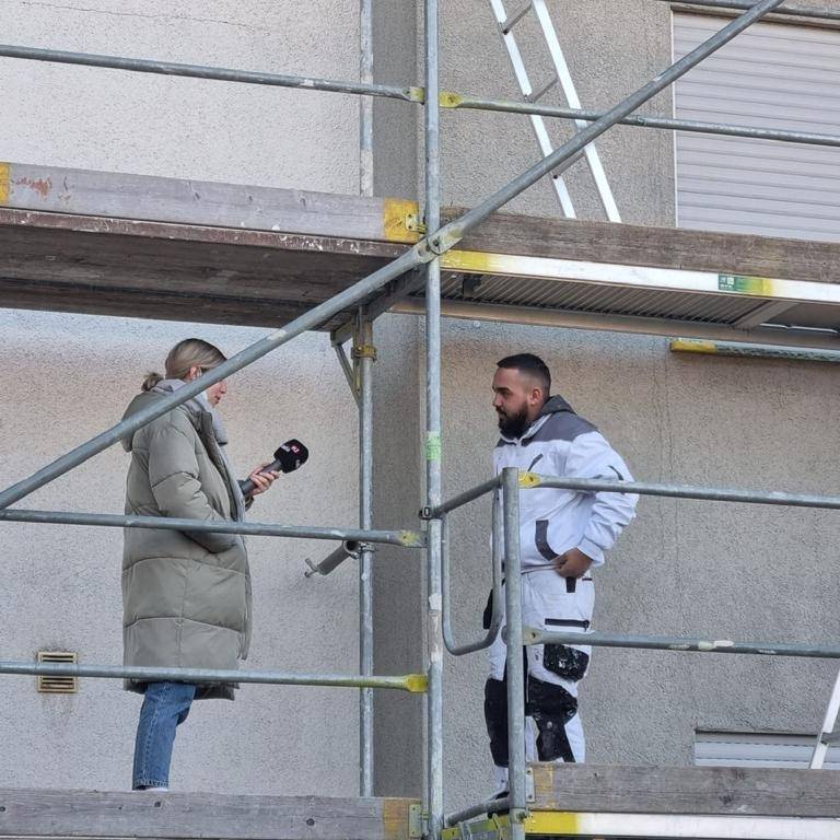 Maler und Lackierer Azubi Shukri Mehmet auf dem Baugerüst in Sölde.