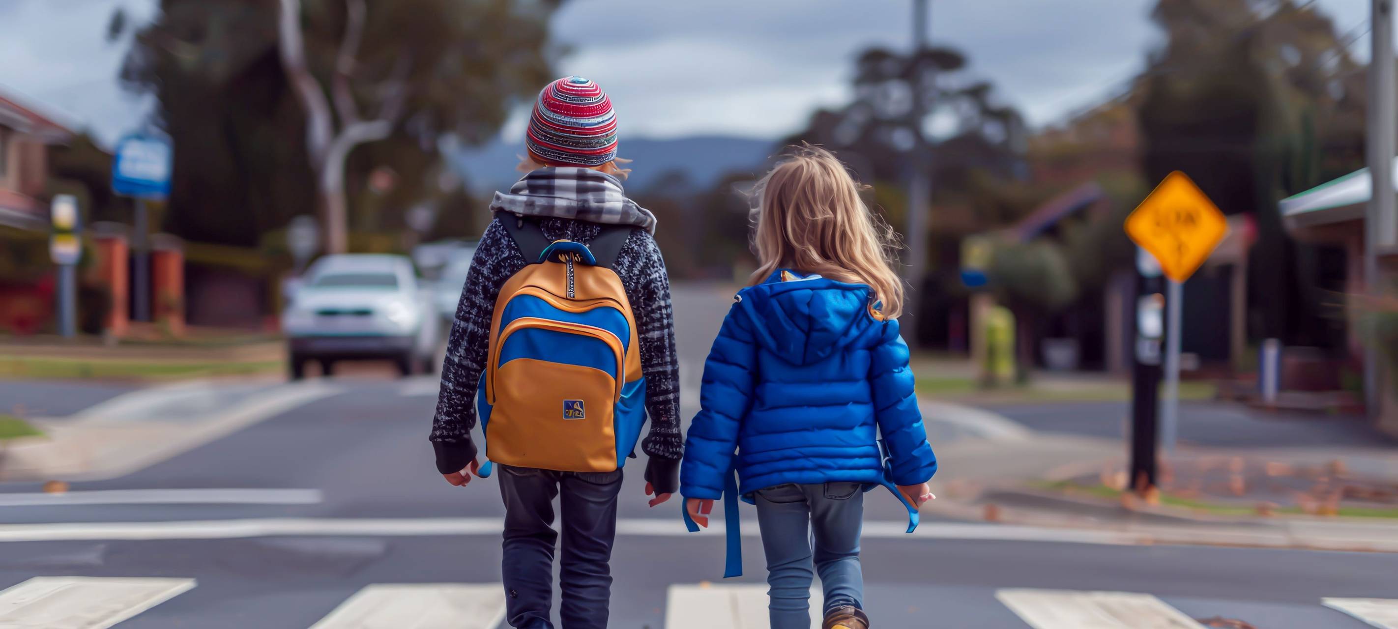 ein Junge und ein Mädchen laufen über einen Zebrastreifen