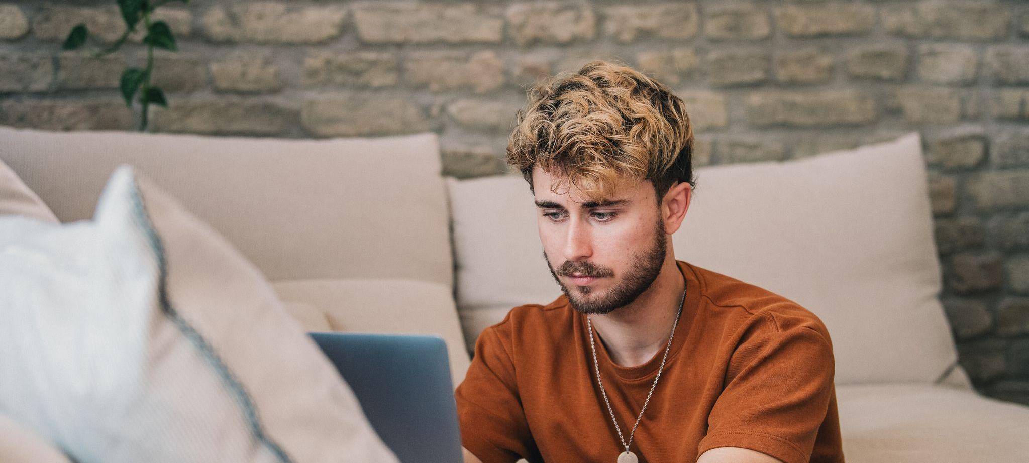 Ein Mann blickt auf ein Laptop